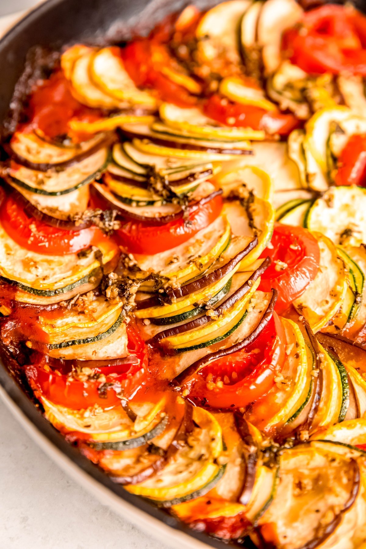 closeup shot of the left half of a skillet filled with Pixar style Ratatouille recipe.