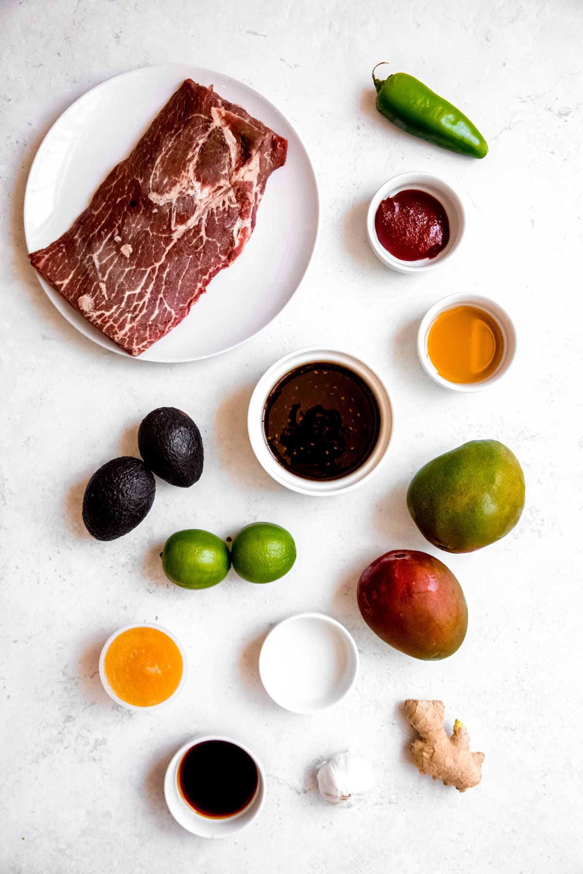 ingredients needed to make korean bbq skirt steak tacos recipe measured out on a white table.