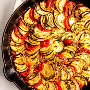 white enameled cast iron skillet filled with homemade remy's ratatouille from Disney's ratatouille movie.