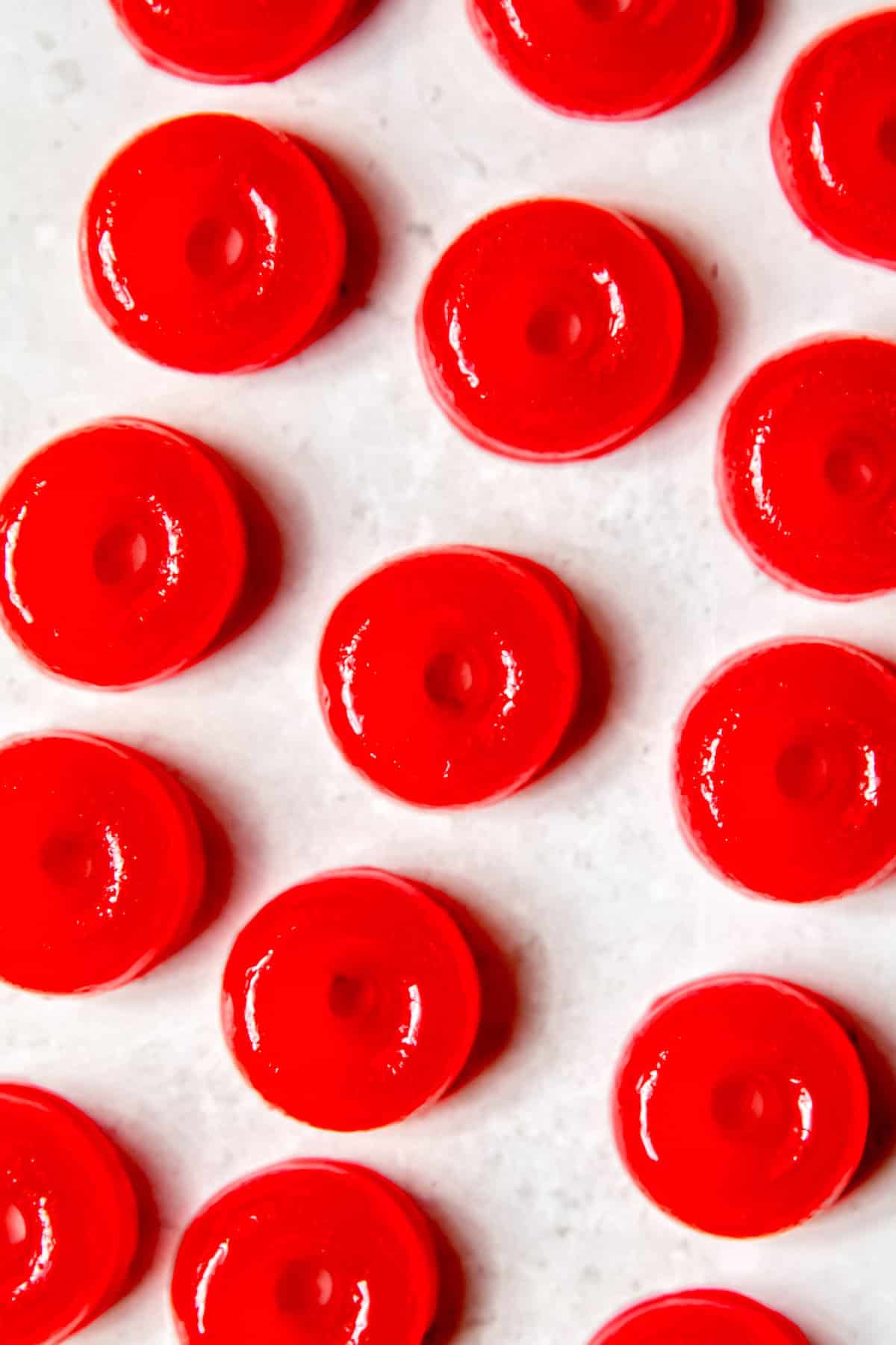 flat lay shot of homemade CBD THC gummies after removing from their molds on a white table.