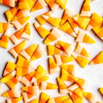 candy corn with honey cut into kernel-shaped pieces on a white table.