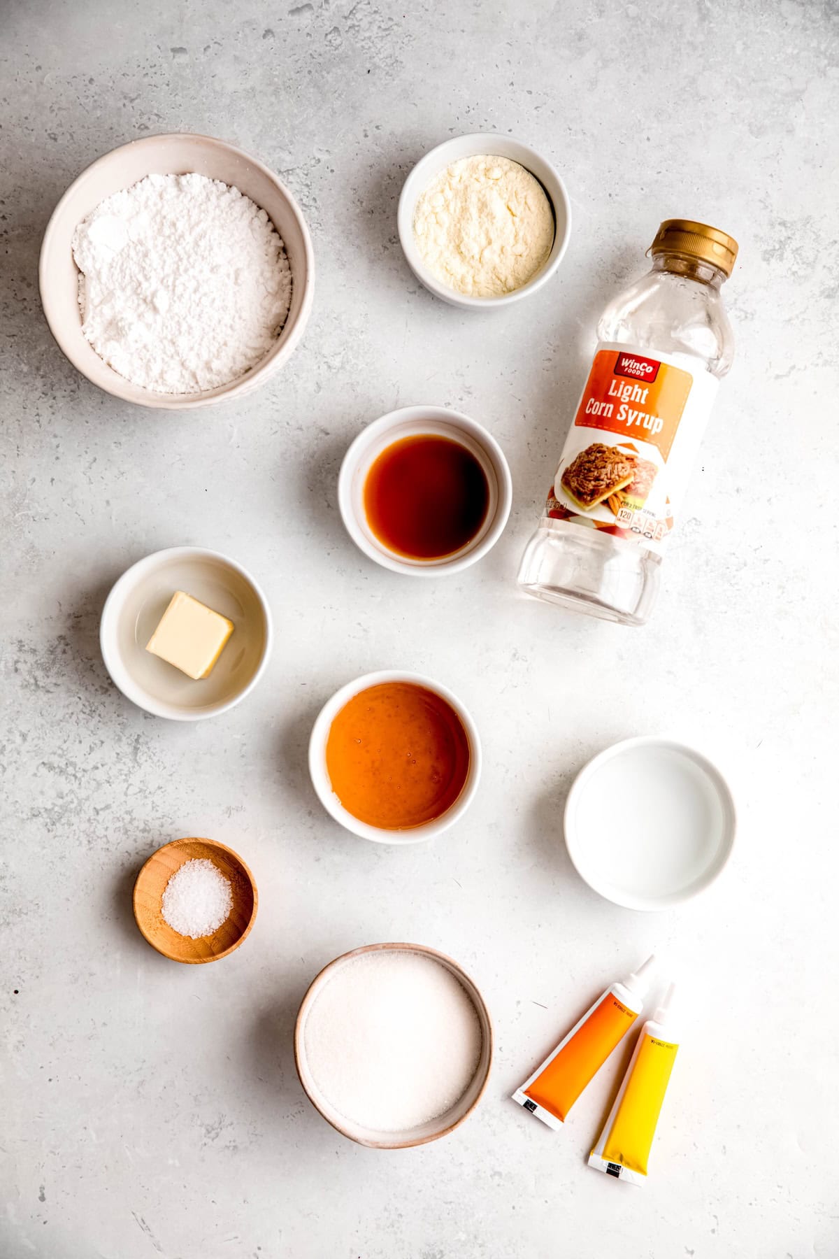 ingredients for making homemade candy corn recipe with honey measured out on a white table.