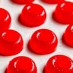 45 degree angle shot of round, red gummy rings that are homemade weed edibles after removing from the mold.