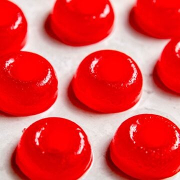 closeup square hero shot of homemade weed gummies on a white surface; they can be made with THC or CBD.