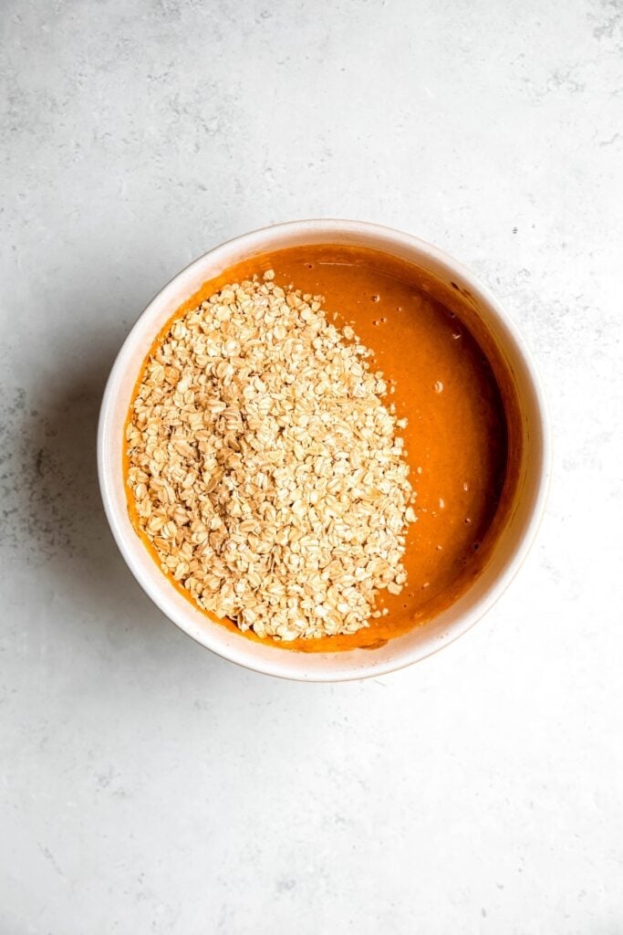 rolled oats added to the bowl with the pumpkin mixture.