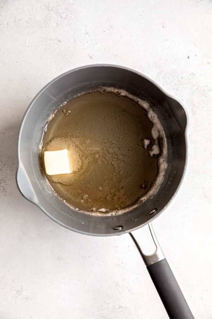 butter added to the sugar-corn syrup mixture after hitting soft ball phase.