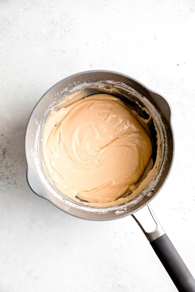 candy corn dough in the pot after stirring in the dry milk mixture.