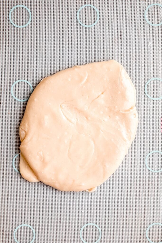 dye-free candy corn dough turned out onto a silicone mat to cool.