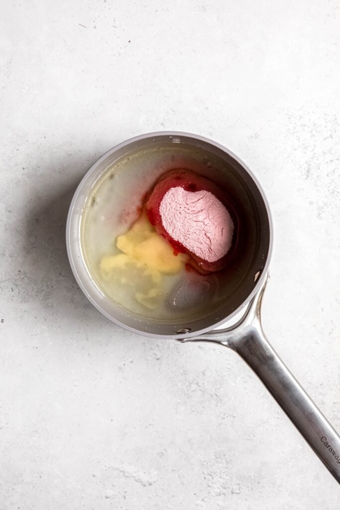 water, cannabis oil, gelatin, and jello mix added to a saucepan.