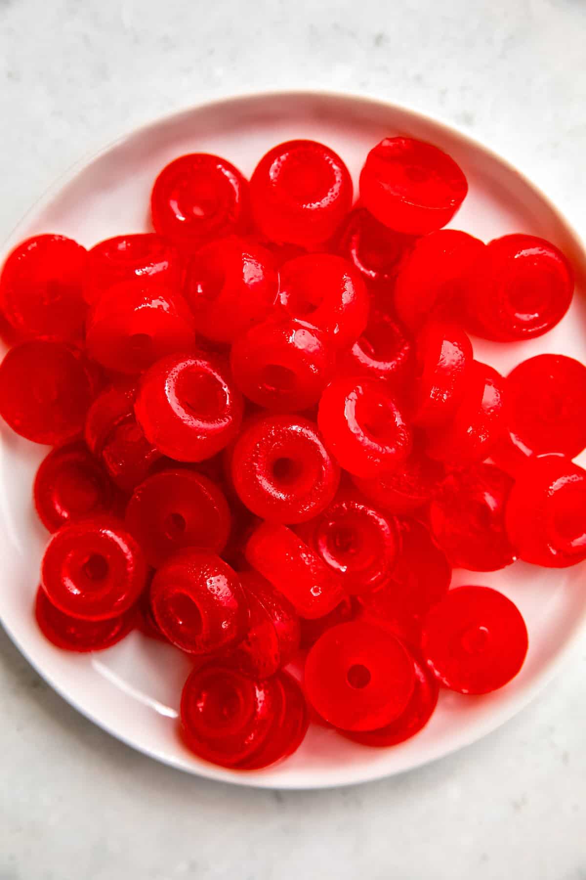 white plate with a jumble of THC infused weed gummies made with Jello.