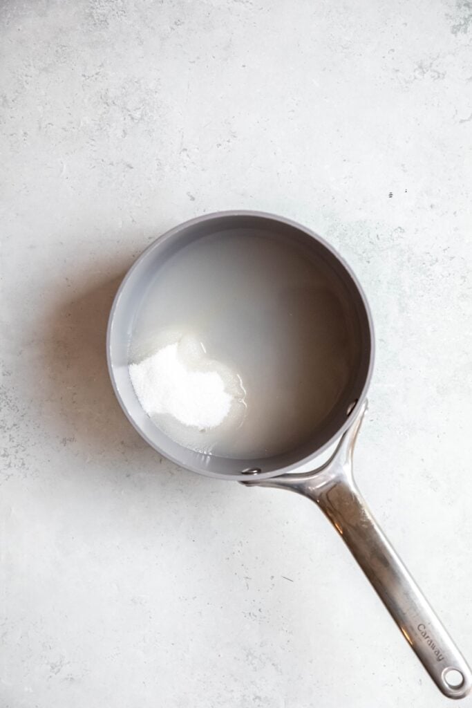 sugar and water added to a saucepan.