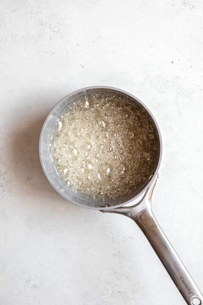 sugar, water, and corn syrup bubbling in a saucepan until reaching 260ºF.