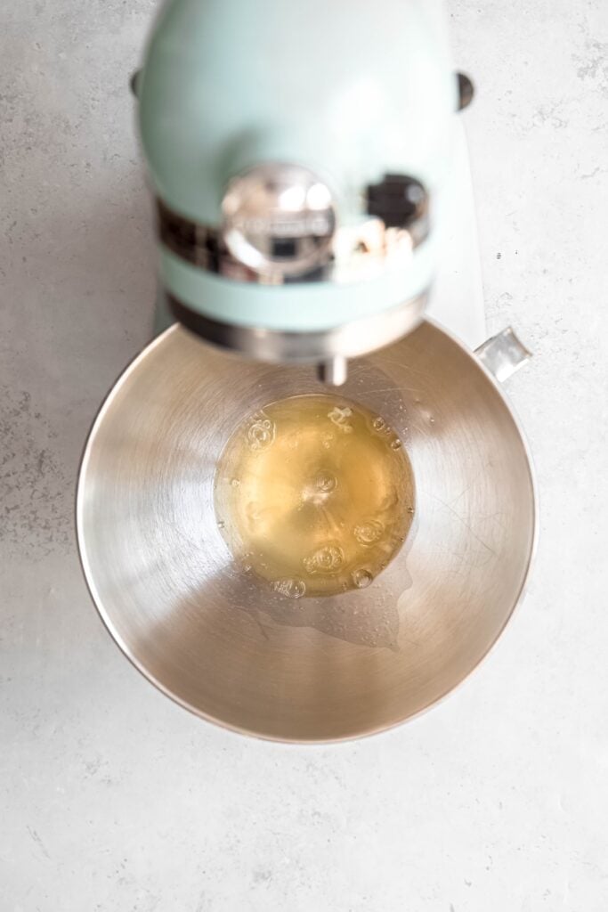 egg whites added to a stand mixer bowl.