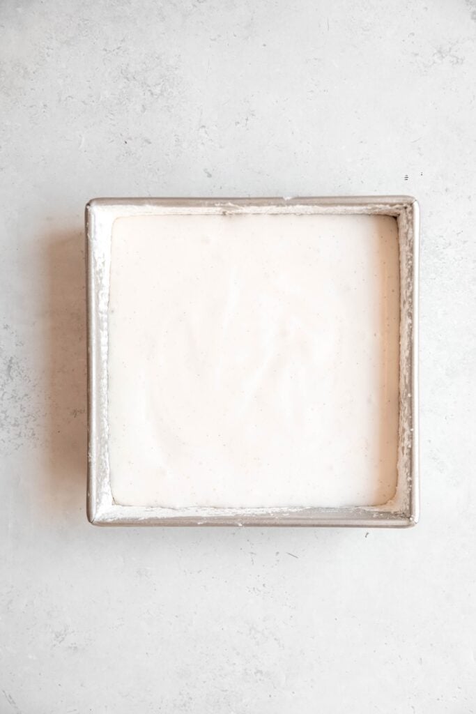 tin after pouring the marshmallow mixture in to set; the powdered sides are still visible at the top of the pan.