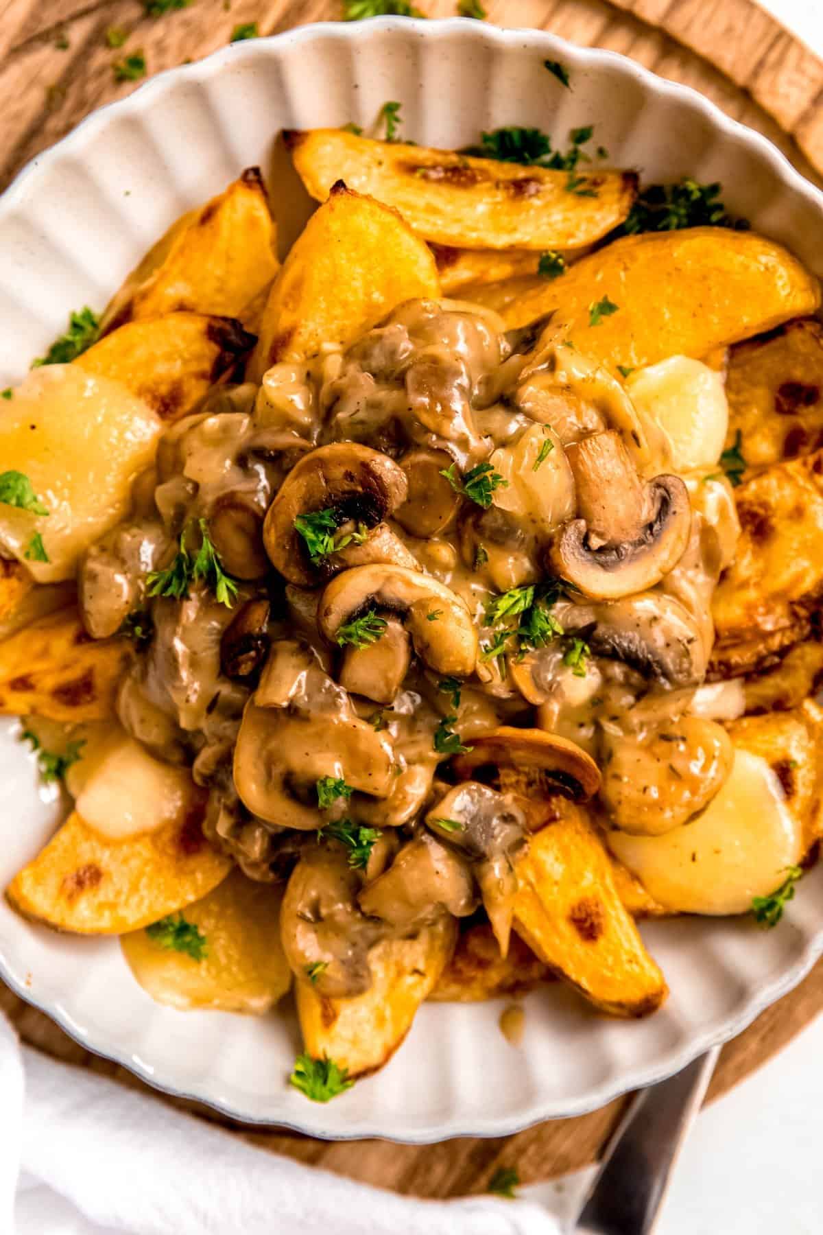 mushroom gravy served over a bowl of roasted potatoes and cheese curds to act as poutine.