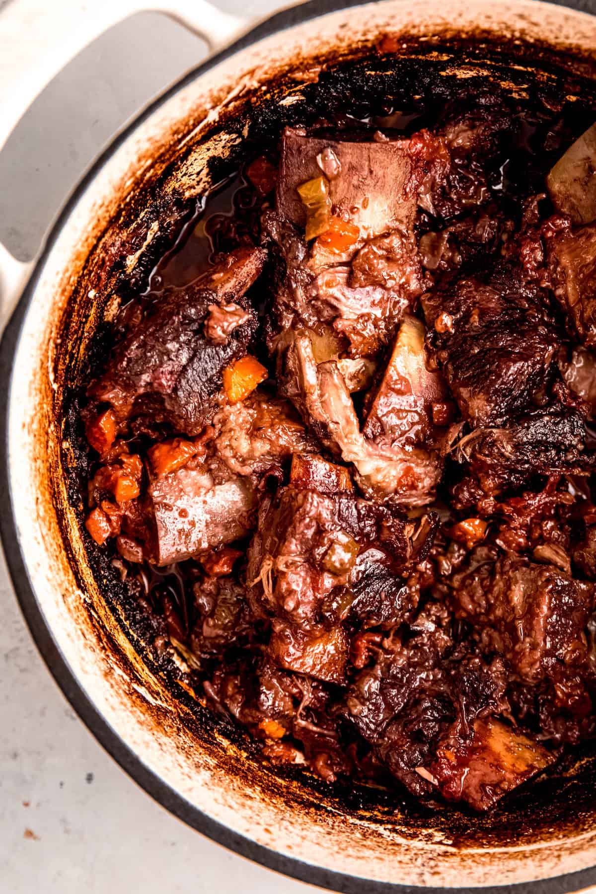 closeup overhead shot of boneless braised short ribs in a dutch oven.