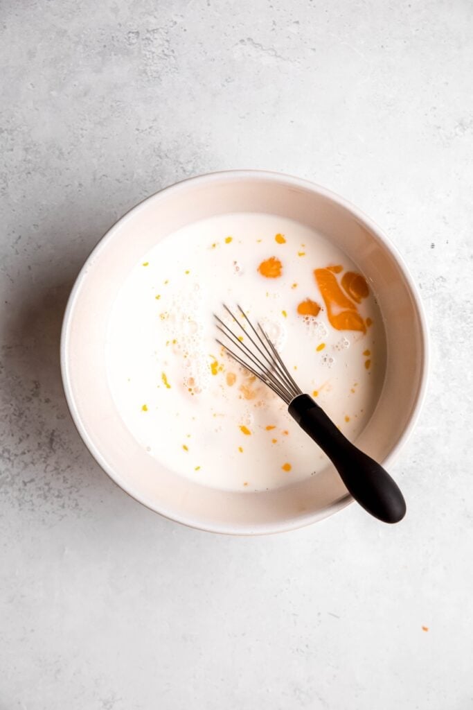 mixing bowl with the milk and eggs for making a breakfast casserole custard.