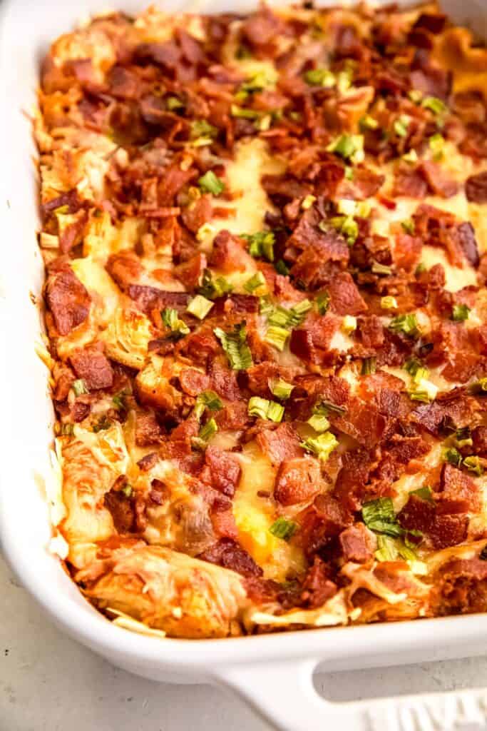 closeup shot of a bacon swiss strata croissant breakfast casserole after baking until golden brown.