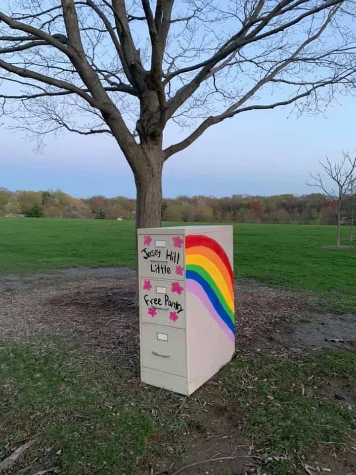 old metal filing cabinet turned into a little free pantry with a rainbow painted on the side and "Jersey Hill Little Free Pantry" on the front.