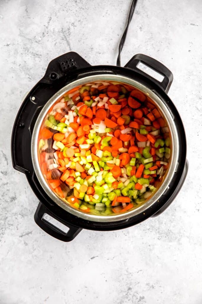 mirepoix being sauteed in an instant pot.