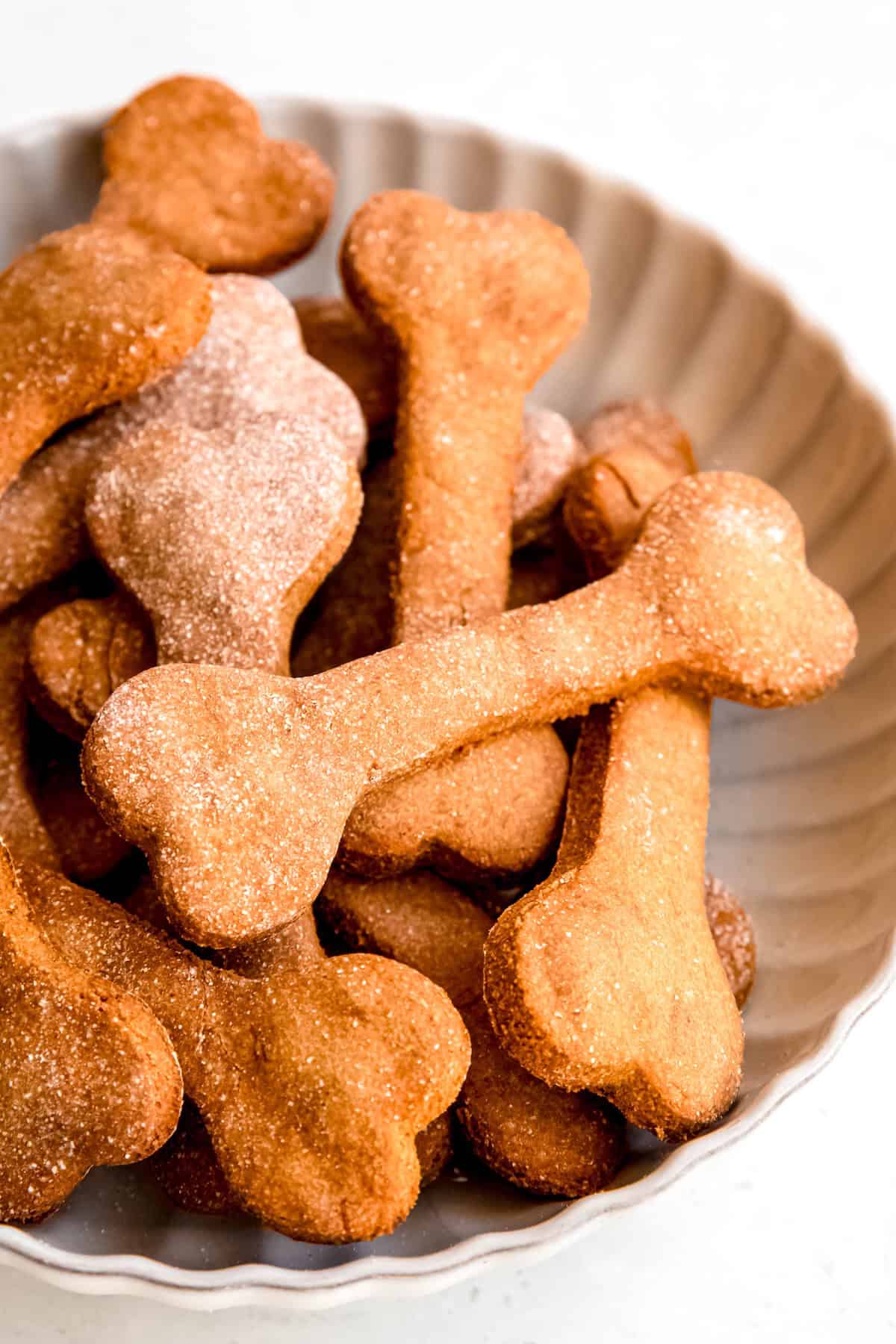 bowl of easy banana peanut butter homemade dog treats shaped like bones.