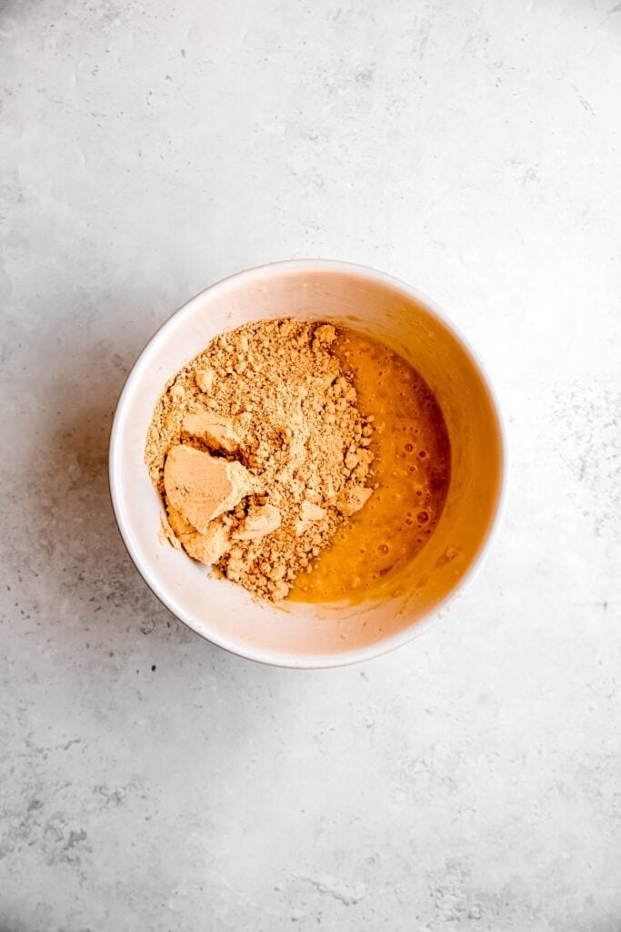 peanut butter powder added to the bowl with the wet ingredients.