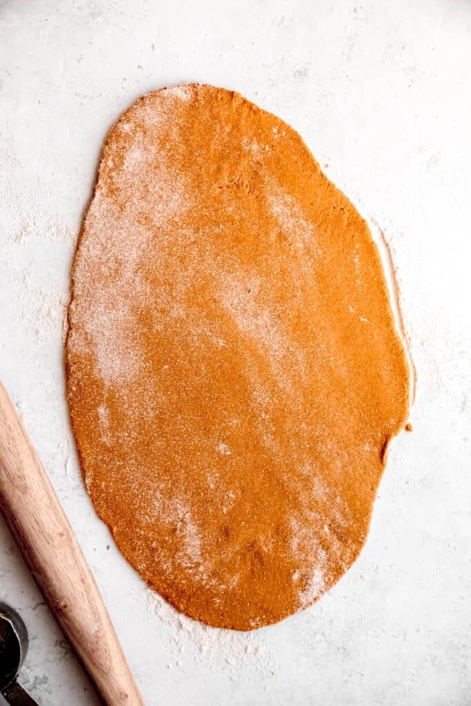 banana peanut butter dog biscuit dough rolled out on a lightly floured surface.