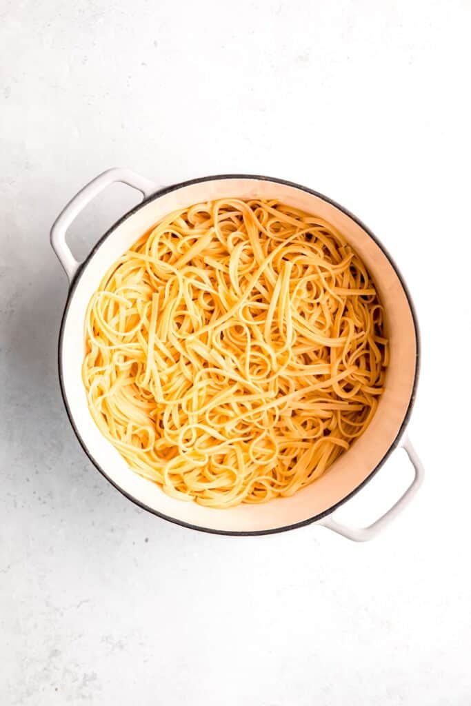 cooked and drained linguine added back to the white dutch oven.