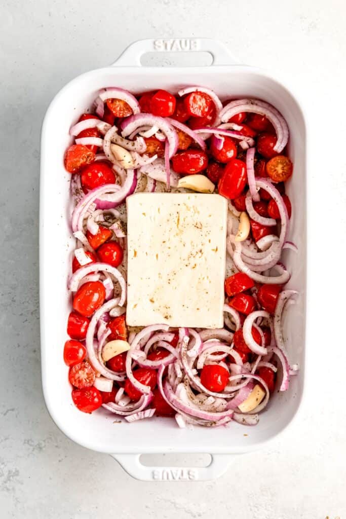 feta placed in the center of the baking dish with the veggies pushed around the sides.