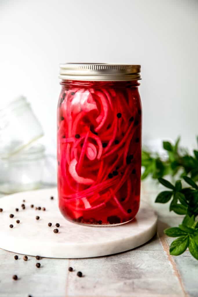 quick pickled red onions in a mason jar after marinating for 2 hours; the color is vibrant pink.