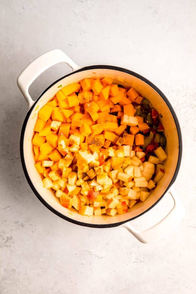 apples, butternut squash and curry powder added to the dutch oven with the sautéed aromatics.