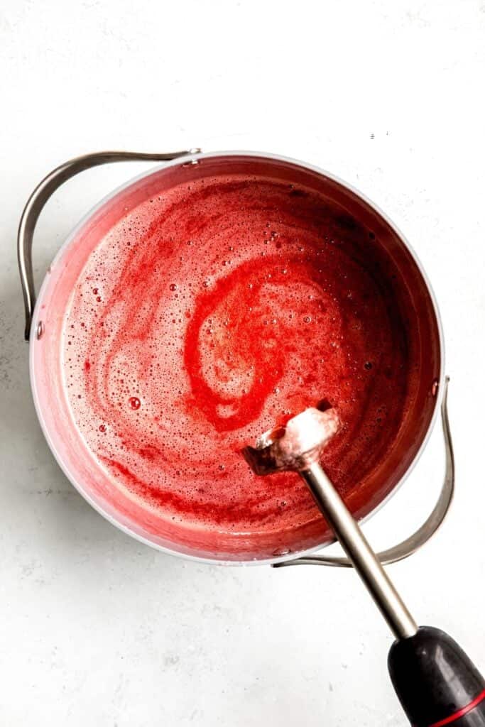 immersion blender used to purée the cooked strawberry jam before canning.