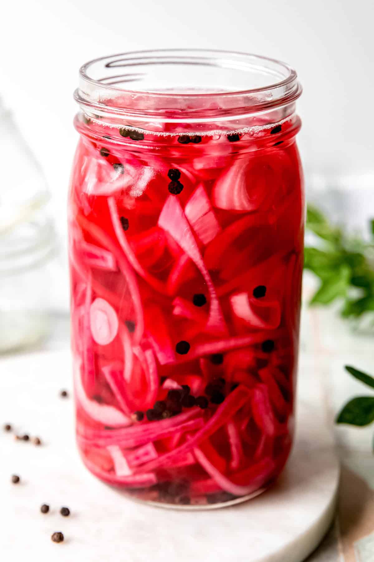 side on view of a mason jar of pickled red onions for tacos and more!