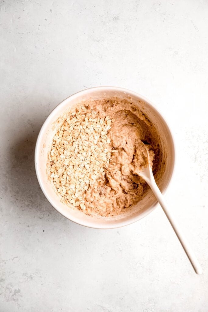 oats added to the bowl with the banana muffin batter.