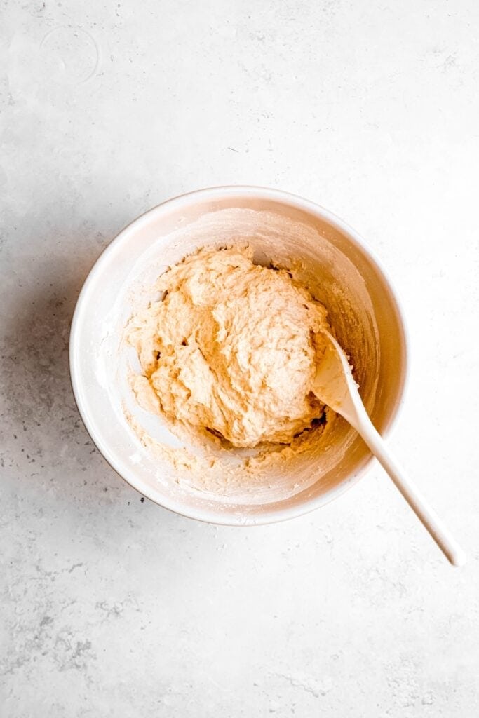 pierogi dough after stirring together with a wooden spoon until craggy.