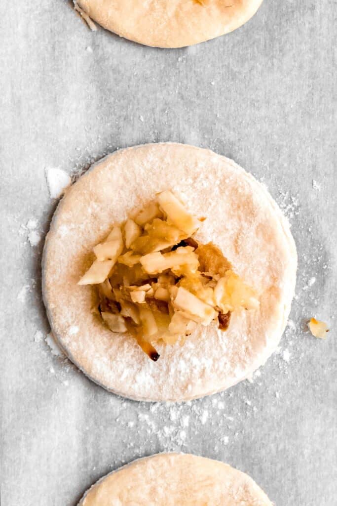 tablespoon of potato cheese and onion filling added to the center of a round of pierogi dough.