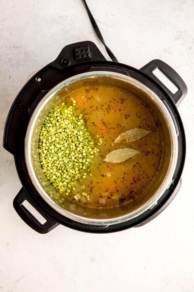 liquid, dried split peas and bay leaves added to the pot.