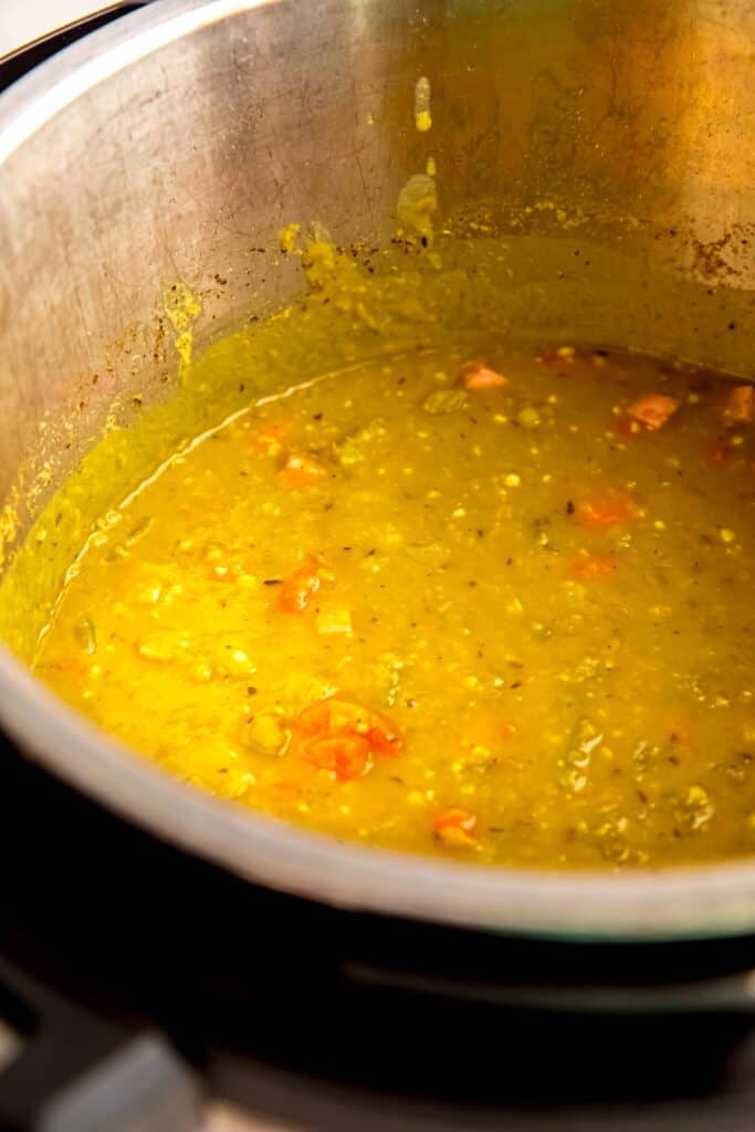 closeup shot of split pea soup with ham in the insert of an instant pot.