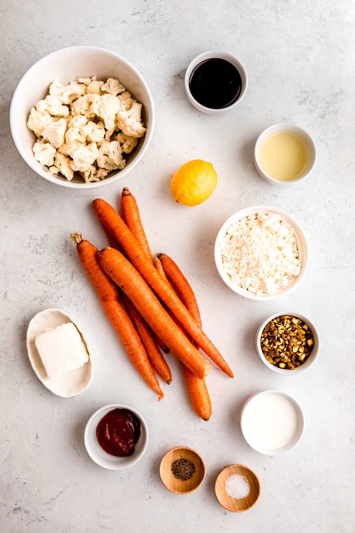 ingredients needed to make harissa roasted carrots and cauliflower with whipped feta, pistachios and pomegranate molasses.